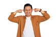 © Khoirul Mahmudin - Irritated young Asian man in casual shirt plugging ears with fingers, disturbed by loud noise isolated on transparent background
