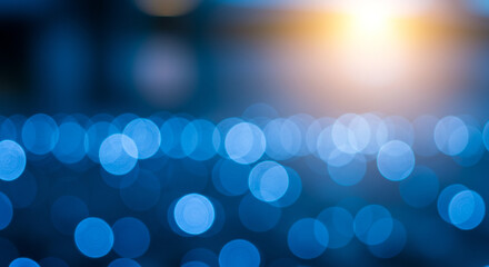 Aufkleber - Abstract image of blue bokeh lights with a bright yellow light source in the upper right corner