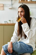 © Bliss - Young pretty woman enjoying a warm drink in a cozy home setting during a quiet afternoon
