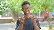 © stockbakers - Casual African Man Beckoning with Hand Outdoors