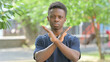 © stockbakers - Casual African Man Making Stop Gesture Outdoors