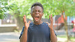 © stockbakers - Screaming and Shouting Casual African Man Outdoors