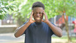 © stockbakers - Casual African Man with Headache Outdoors