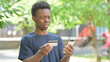 © stockbakers - Casual African Man with Online Transaction Failure Outdoors