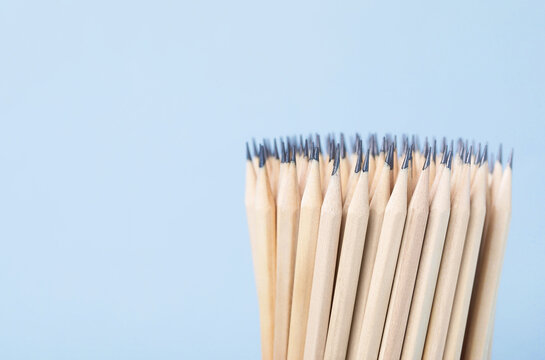 Many graphite pencils on grey background, closeup. Space for text