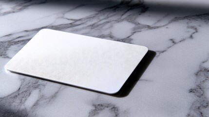 Poster - Plain white card resting on a polished marble surface with soft shadows and highlights