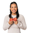 © Asier - Young Filipina holding tomatoes, fresh and healthy produce