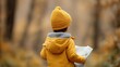 © ParinApril - Child in Yellow Jacket and Hat Holding Map in Autumn Forest Surrounded by Colorful Foliage Exploring Nature and Adventure
