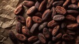 Cocoa Beans on Paper: A raw cocoa bean heap lies atop a crumpled brown paper, awaiting transformation into delightful chocolates and confectioneries.