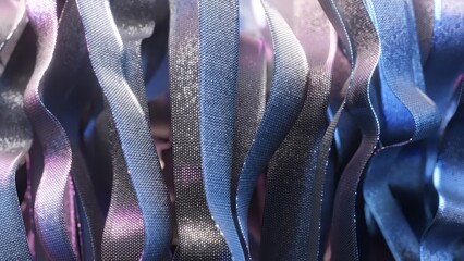 Poster - Metallic ribbons with iridescent shimmer gently undulating, weaving luminous blue and purple hues into a hypnotic visual choreography of fluid motion and elegant design