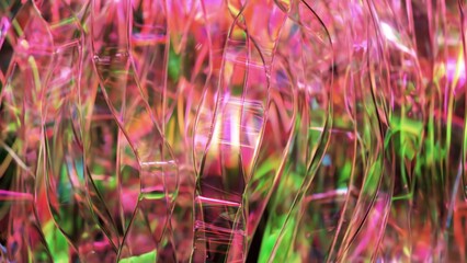Poster - Iridescent pink and green plastic ribbons gently swaying, intertwining, reflecting light with translucent surfaces, creating dynamic color and texture composition