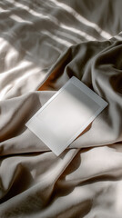 Leinwandbilder - Blank instant photo paper on soft beige fabric with sunlight and shadow, minimal and calm mood, perfect for creative design or memory concept