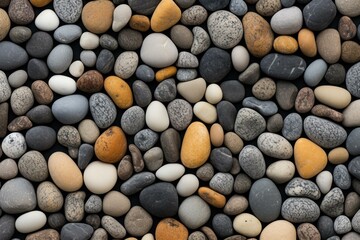 Poster - Multicolored pebbles creating a seamless texture on a black background, perfect for backgrounds and design projects
