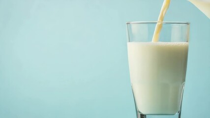 Aufkleber - A glass of milk being poured into another