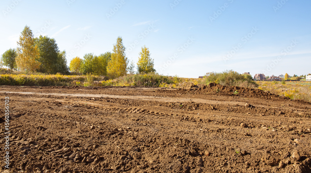 Empty land plot with tire prints prepared for new housing in rural area ...