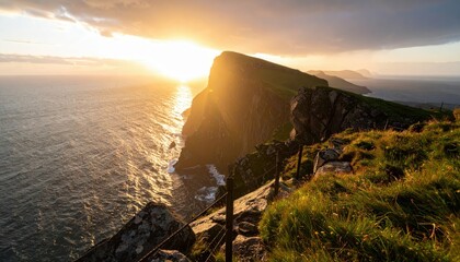 Poster - Dramatic Dawn Light Over Coastal Cliff with Shimmering Ocean Surface