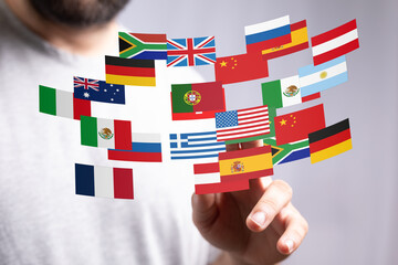 Poster - Image of a person interacting with a digital display of various national flags, representing global reach and international business.
