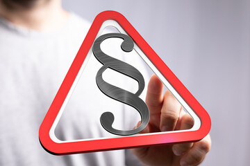 Poster - Hand points to a digital warning sign with a paragraph symbol, emphasizing legal matters.