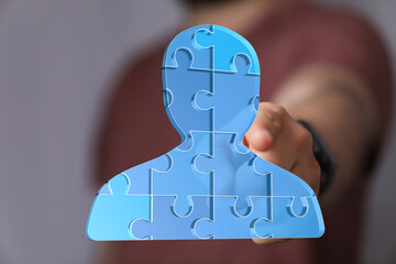 Poster - Abstract image of a person made of puzzle pieces, symbolizing teamwork, collaboration, and unity.