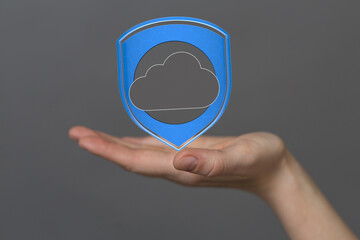 Poster - Image of a hand holding a digital shield protecting cloud data, symbolizing secure cloud storage and data protection.