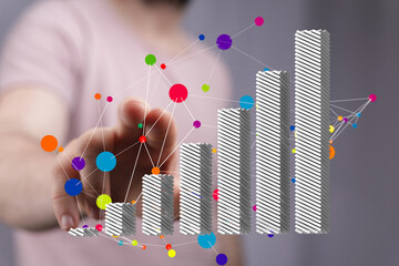 Poster - Stock photo of a hand interacting with a 3D bar graph showing growth and data connections.