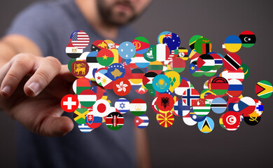 Poster - A hand interacts with a digital display of various national flags, representing global connection.