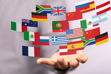 Poster - Image of a hand holding various flags, symbolizing global business, international relations, and world connections.