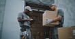 © Framestock - Diverse Workers Taking Cardboard Boxes with Online Orders and E-Commerce Goods to Logistics Retail Warehouse. African American Manager Scanning Parcels with Barcode Scanner, Using Tablet Computer.
