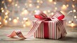 © Patwarin - A beautifully wrapped present with a festive striped ribbon sits on a rustic wooden surface, illuminated by a warm and enchanting bokeh of soft lights.
