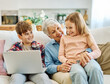 © Lumos sp - Family grandmother and grandchildren granddaughter and grandson, girl and boy, having fun using laptop at home