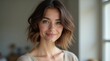 © Horizen - Smiling woman with short hair and natural makeup in sunlit room