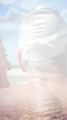 Poster - Animation of glowing light over happy senior couple in swimming hats by seaside