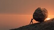 © mila103 - A person struggles to push a large boulder uphill against a vibrant sunset backdrop. The sky glows with warm colors as the sun sets, creating a powerful visual contrast.