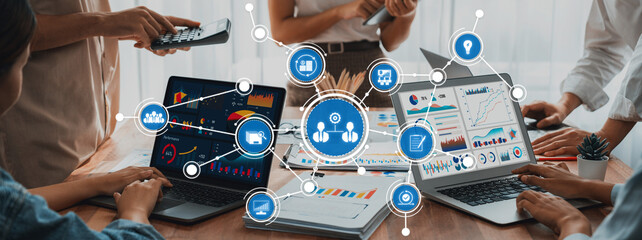 Poster - A dynamic business meeting scene showcasing teamwork with laptops displaying data analytics and graphics, fostering innovation and strategy in a modern workspace. Amity
