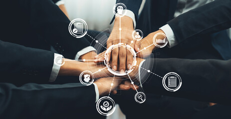 Poster - A diverse business team stacks their hands together, symbolizing unity and partnership. Surrounding them are digital icons representing growth, strategy, and success in a connected world. Amity