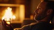© Elena - Warm cozy scene of a mature man relaxing by the fireplace with soft flickering flames illuminating his serene face, holding a glass of whiskey in a comfortable and intimate living room setting.