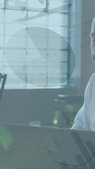 Poster - Animation of infographic interface over african american man checking laptop while working in office