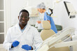 © JackF - Confident qualified african american dentist posing in modern dental clinic office, looking at camera with smile ..