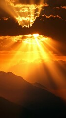 Poster - Golden sun rays piercing through clouds over dark mountain silhouette