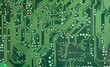© Tomasz - Green printed circuit board closeup with lots of electronic pathways, abstract tech simple background texture, computing, electronics PCB design hardware electronic engineering backdrop concept, front