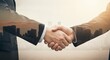 © Renderis - Two people shaking hands with a cityscape overlay suggesting a business deal.