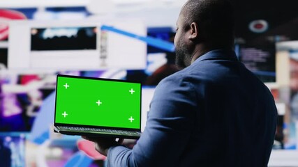 Poster - Professional content creator in a multitasking space holds green screen, leveraging social media, internet big data and cloud systems. Engaging followers to boost digital presence. Camera B.