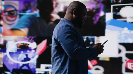 Poster - Young black professional explores a tech driven environment with visual data, content feeds and applications. Symbolizing entertainment, social reach and digital transformation. Camera B.