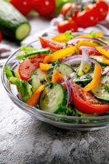 Poster - Fresh colorful vegetable salad with sliced tomatoes cucumbers bell peppers and red onions served in a clear glass bowl on a light textured background