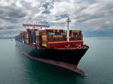 logistic cargo container ship sailing in sea to import export goods and distributing products to dealer and consumers across worldwide,