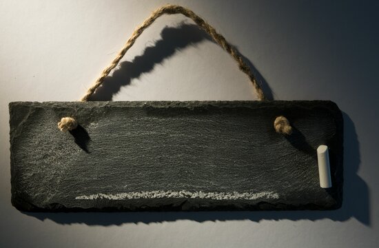 Hanging chalkboard on dark background
