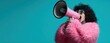 © MP Studio - The confident woman passionately expressing herself with a pink megaphone.