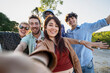 © Lomb - Happy diverse friends taking outdoor group selfie during summer day trip