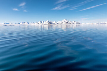 Wall Mural - the blue arctic ocean, pristine snow covered mountains and summer sky. svalbard, a norwegian archipe