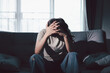 © doidam10 - Despair sorrow person in empty dark room, Depressed young woman covering face with hands. Young woman coping with distress covering face. mental health concept. Boring sad upset frustrated stressed.
